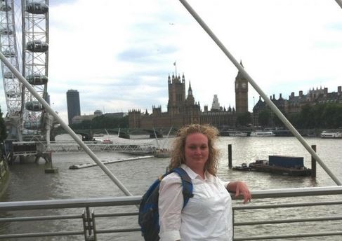 Sonya Carroll on the Millennium Bridge near the London Eye and Parliament